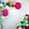 LED neon heart personalized with the bride & groom's initials. Shown here on a mesh background surrounded by balloons. Photo from CustomNeon.com.au