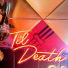Til Death Neon Sign in LED flex shown in orange, hung from a frame at an event - photo from Custom Neon by Neon Collective