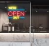 WE'RE OPEN 24/7 in brilliant yellow and red, with bright blue lines shown in a cafe window - from CustomNeon.com.au