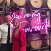 You're My Favourite pink light sign in front of wine barrels at a wedding - from Custom Neon