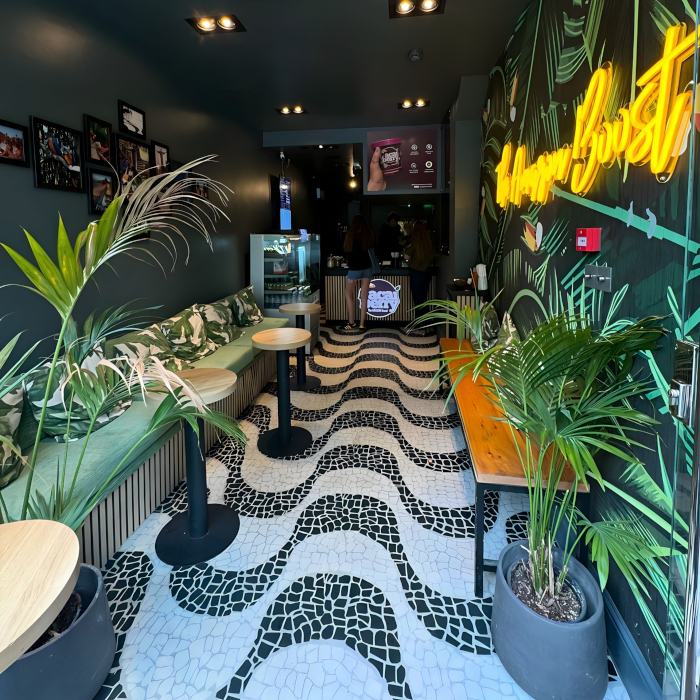 Custom Neon® large dark yellow LED neon sign on green jungle wallpaper @acaiberryfoods in Chelsea