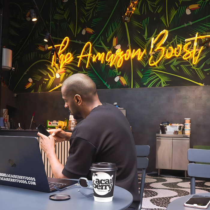 Custom Neon® large yellow LED neon sign on jungle wallpaper @acaiberryfoods at Camden Market