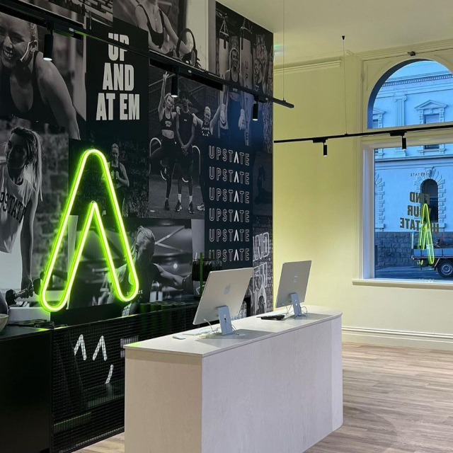 Yellow Custom Neon® front desk arrow sign @loopelec