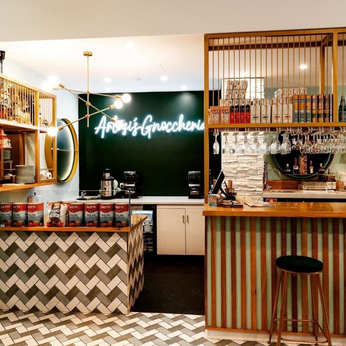 Artusi Gnoccheria white Custom Neon® sign on a dark wall in an Italian restaurant @helloartusi_gnoccheria