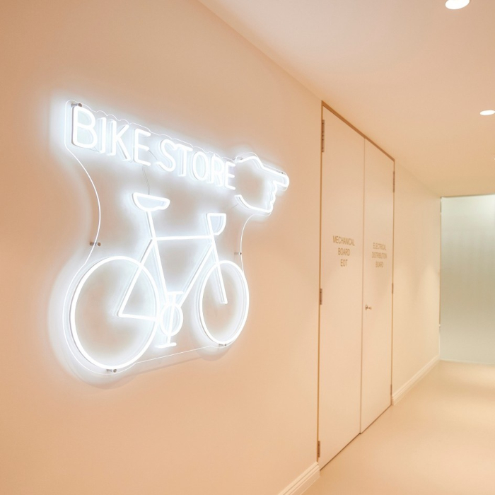 White directional sign by Custom Neon® @inoneprojects