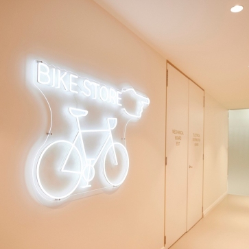 White directional sign by Custom Neon® @inoneprojects