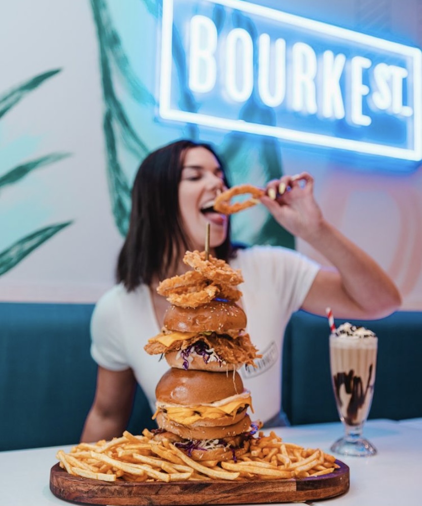 Custom Neon® made restaurant logo signage in background of user-generated content