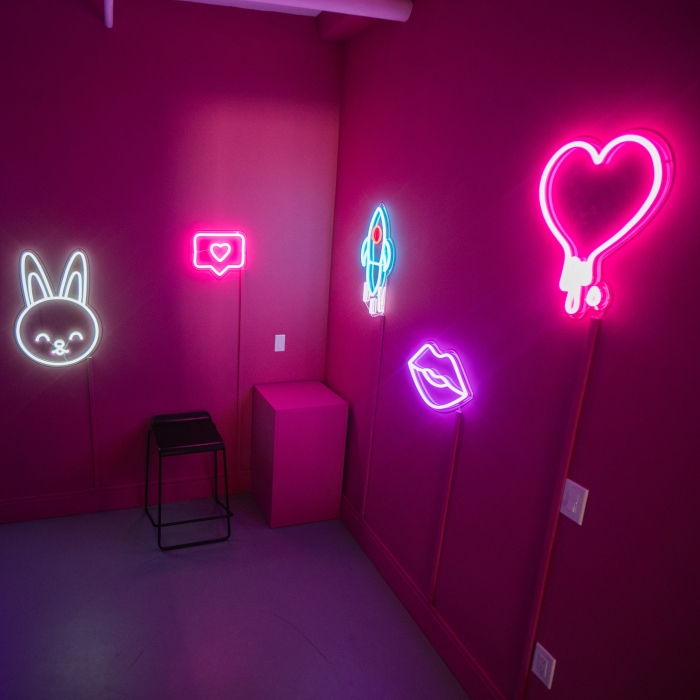 Bunny face lips heart and rocket ship Custom Neon® artwork on pink walls in the Samsung Flip Side Pop-Ups