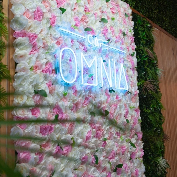 Custom Neon® Logo light sign on a flower wall @cafeomnia