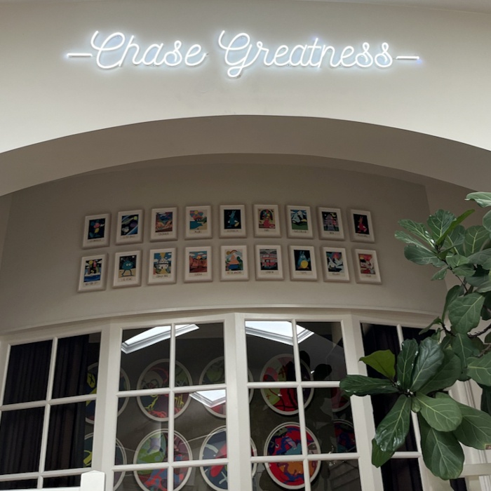 Chase Greatness white Custom Neon® quote sign on white wall @velvethammermgmt
