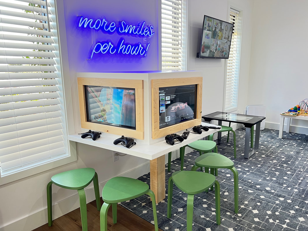 Custom Neon® blue More Smiles Per Hour tagline sign @chompersdental