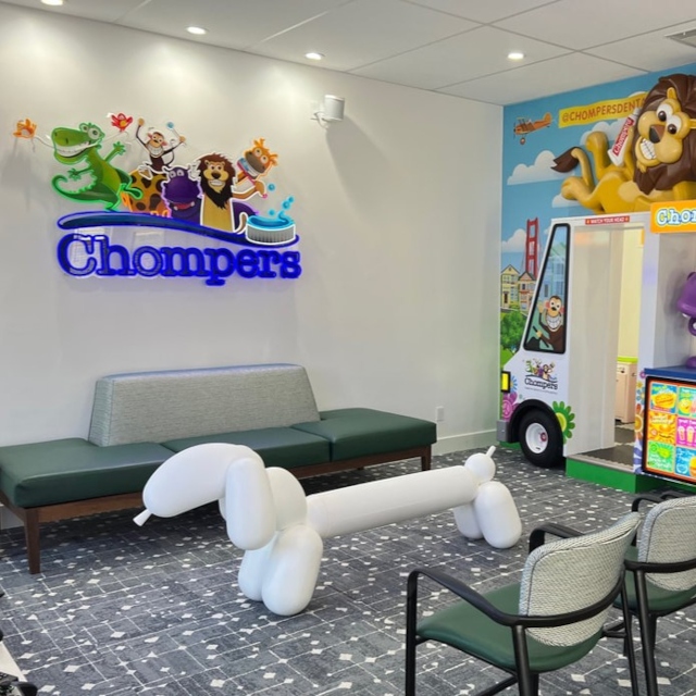 Chompers colourful logo sign on a white wall at the Chompers Dental clinic