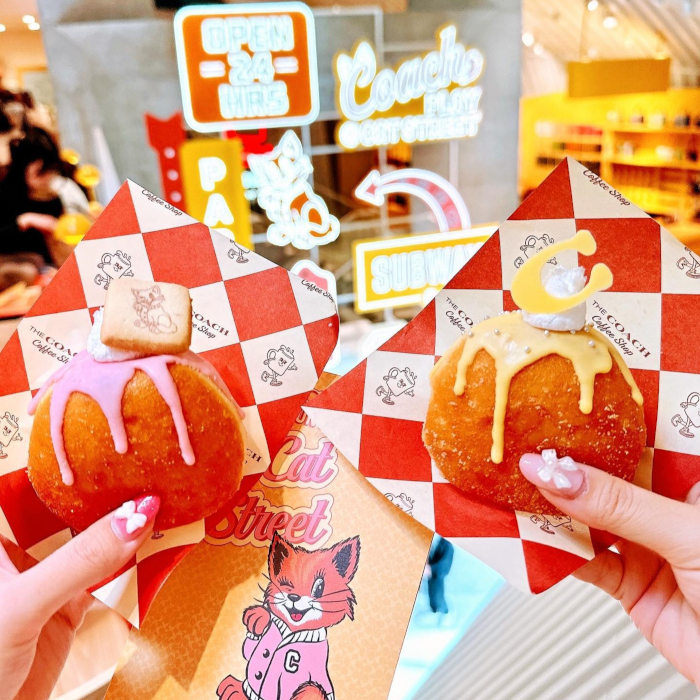 Custom Neon® signs in background of a selfie sign taken in the Coach Café at Coach Play @Cat Street @coach_japan photo by @apichu001