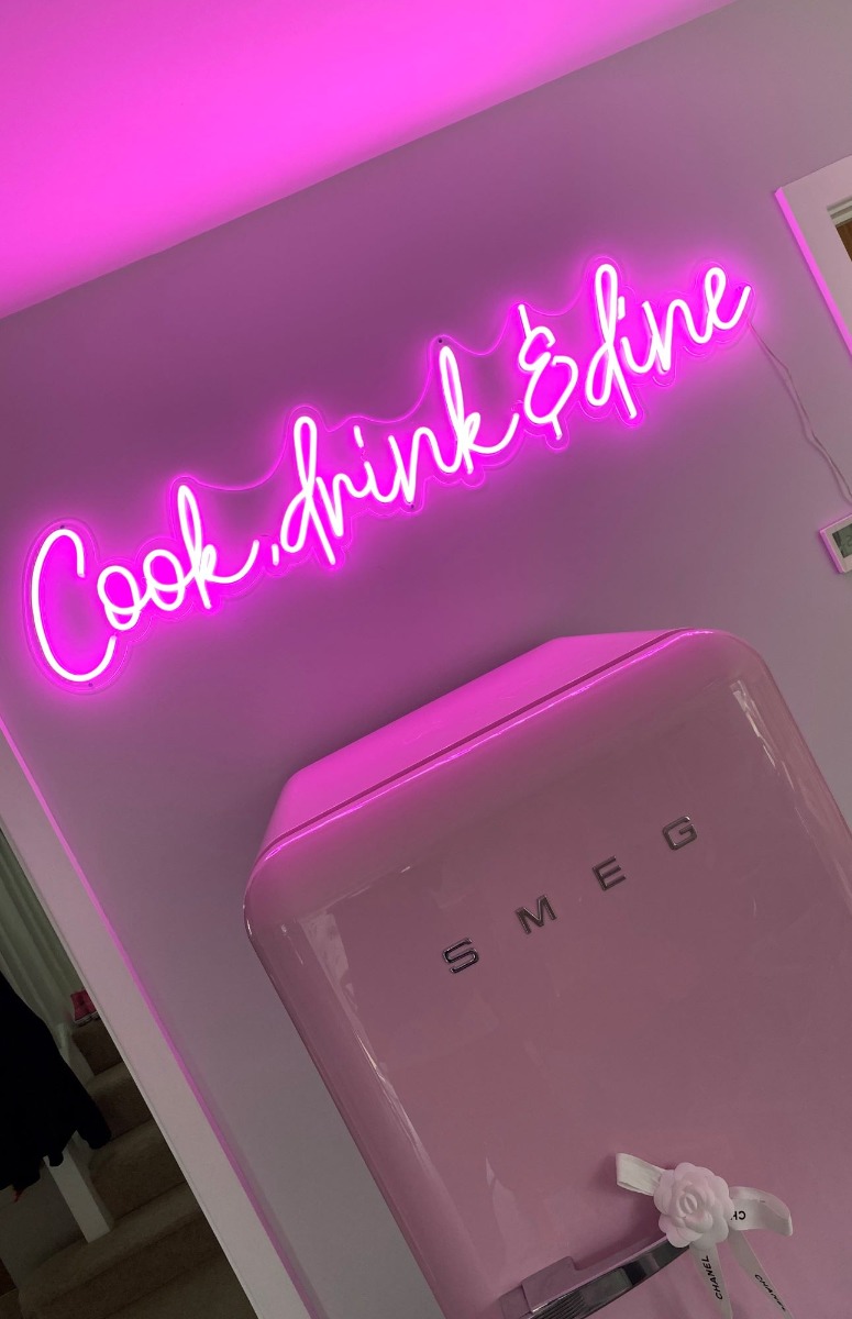 Cook Drink & Dine pink Custom Neon® kitchen sign above a pink Smeg fridge