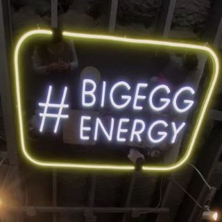 Custom Neon hashtag sign #bigeggenergy on the ceiling @crackedeggery