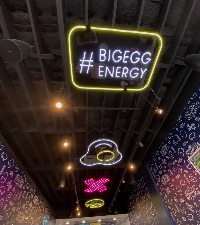Custom Neon hashtag sign #bigeggenergy on the ceiling @crackedeggery