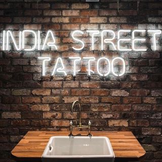 Tatoo studio name sign by Custom Neon® on dark brick wall @indiastreettattoo