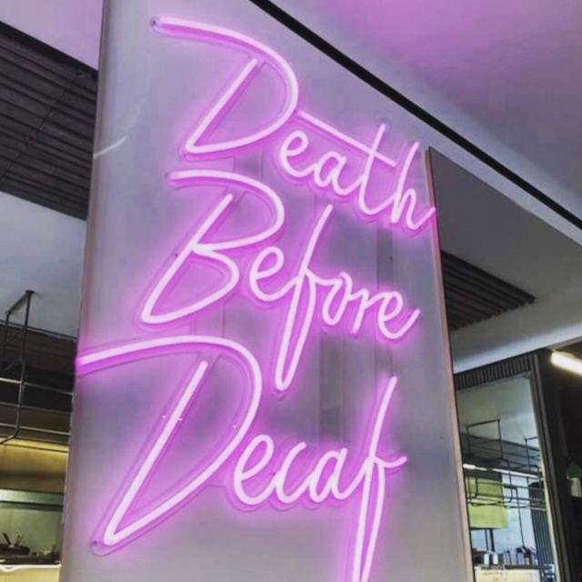 Custom Neon® pink Death Before Decaf sign @skullandrosecafe