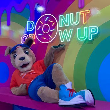 Colorful Custom Neon® sign on a rainbow wall @sundaedonuts