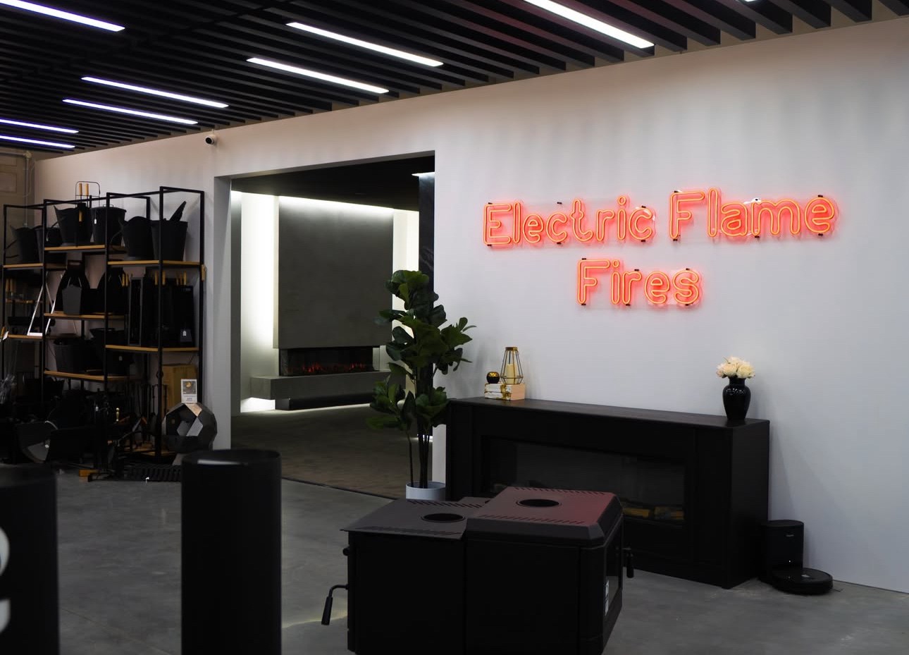 Electric Flame Fires red LED neon double lined wayfinding sign made by Custom Neon® mounted on a white wall in the Pivot Stoves showroom