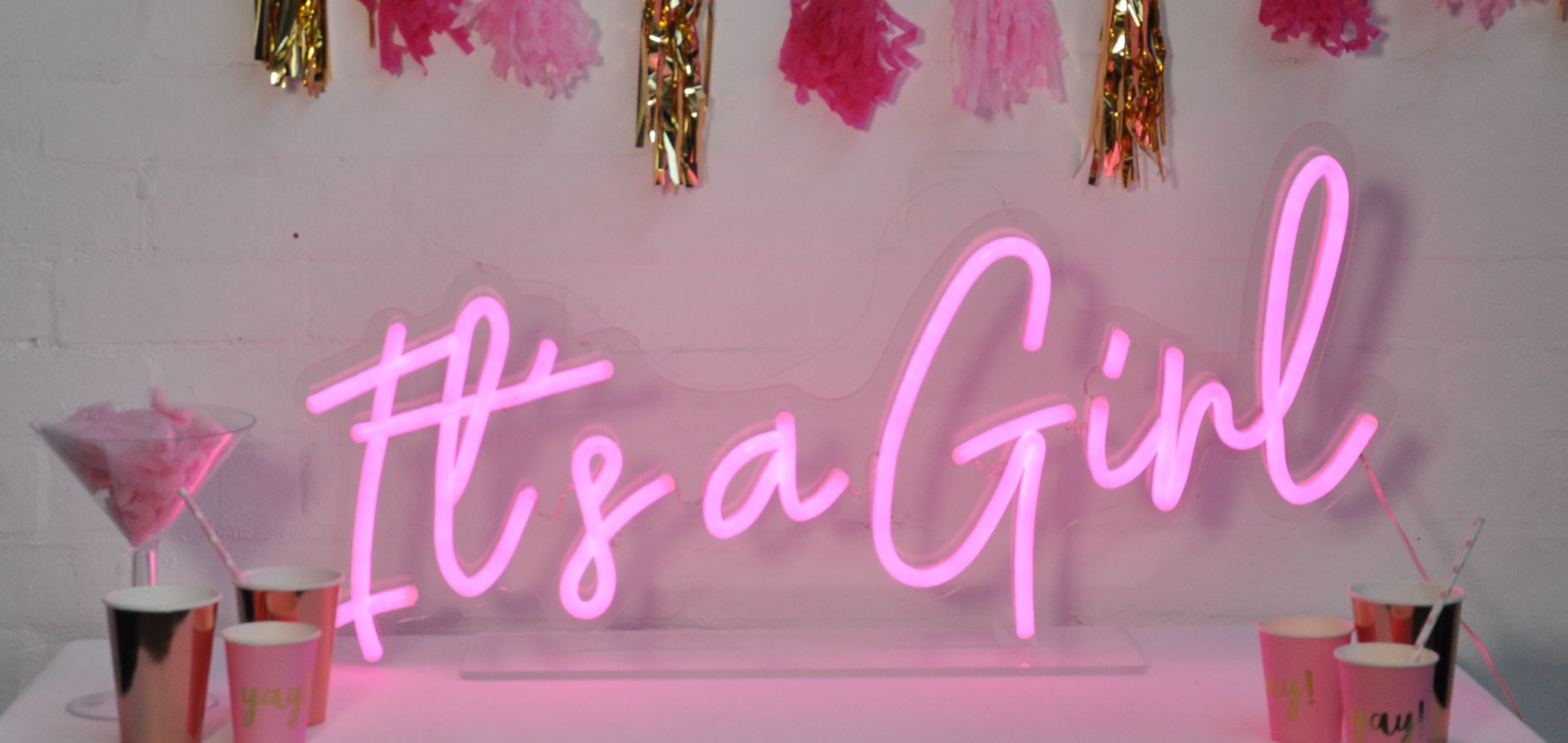 Custom Neon® pink It's a Girl sign on acrylic stand