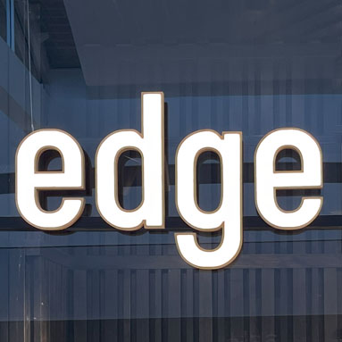 White face lit sign in a shopping mall