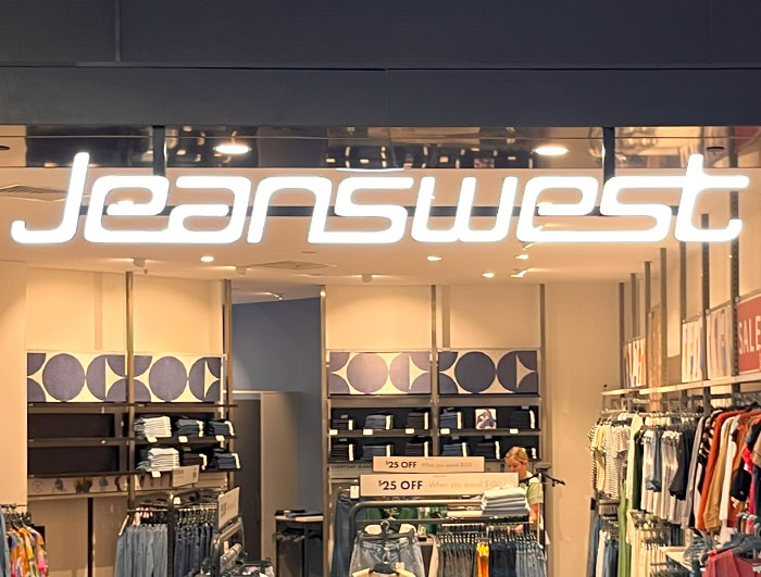 Jeanswest logo front lit store window sign