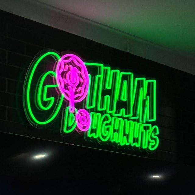 Pink and green Custom Neon® bakery logo sign @gotham.doughnuts
