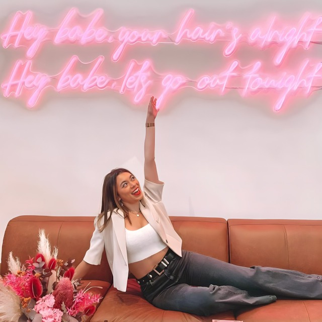 Large pink Custom Neon® quote sign on the Insta wall @etchersalon