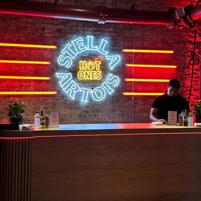 Hot Ones Stella Artois Custom Neon® logo signs behind the bar at the Hot Ones Live event in Chicago IL organised by @thesuperproducers @emdahlquist