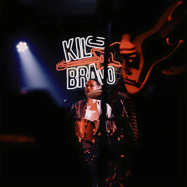 Custom Neon® red & white band logo above the stage during a performance by @kilobravomusic