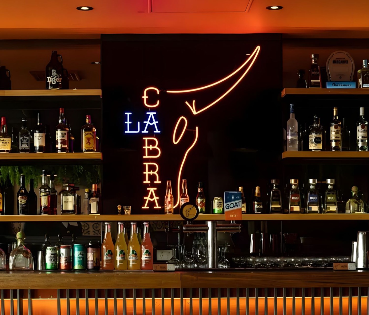Custom Neon® made Mexican restaurant logo behind the bar @lacabramexican