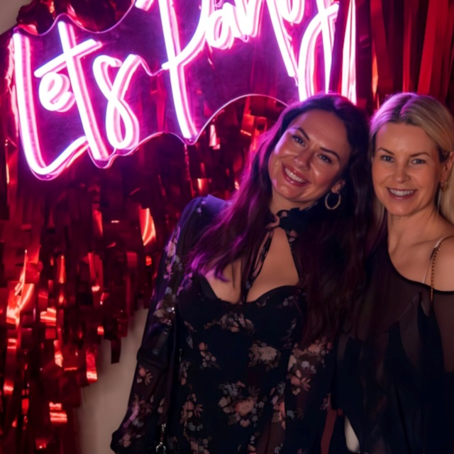 Let's Party pink Custom Neon® light backdrop on a streamer wall @thewarehouse