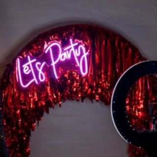 Orange Custom Neon® Let's Party sign on streamer arch @thewarehouse @johnhphoto