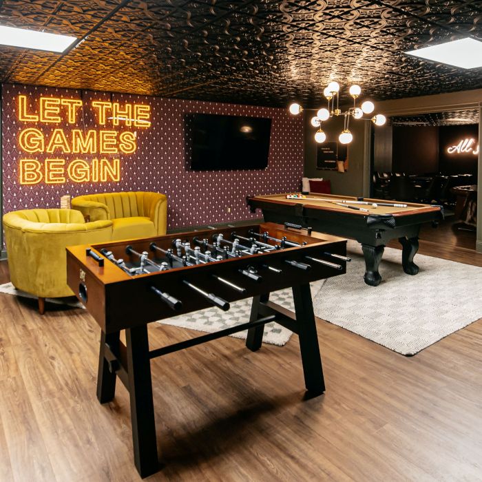Let the Games Being large double lined LED Custom Neon® sign on the wall of a modern games room designed by Somerled