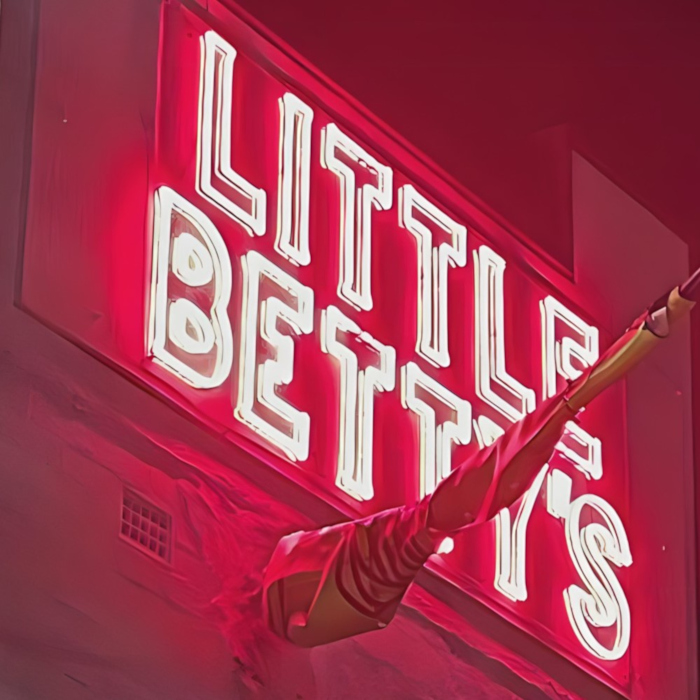 Custom Neon® red restaurant name sign on the building exterior @little_bettys