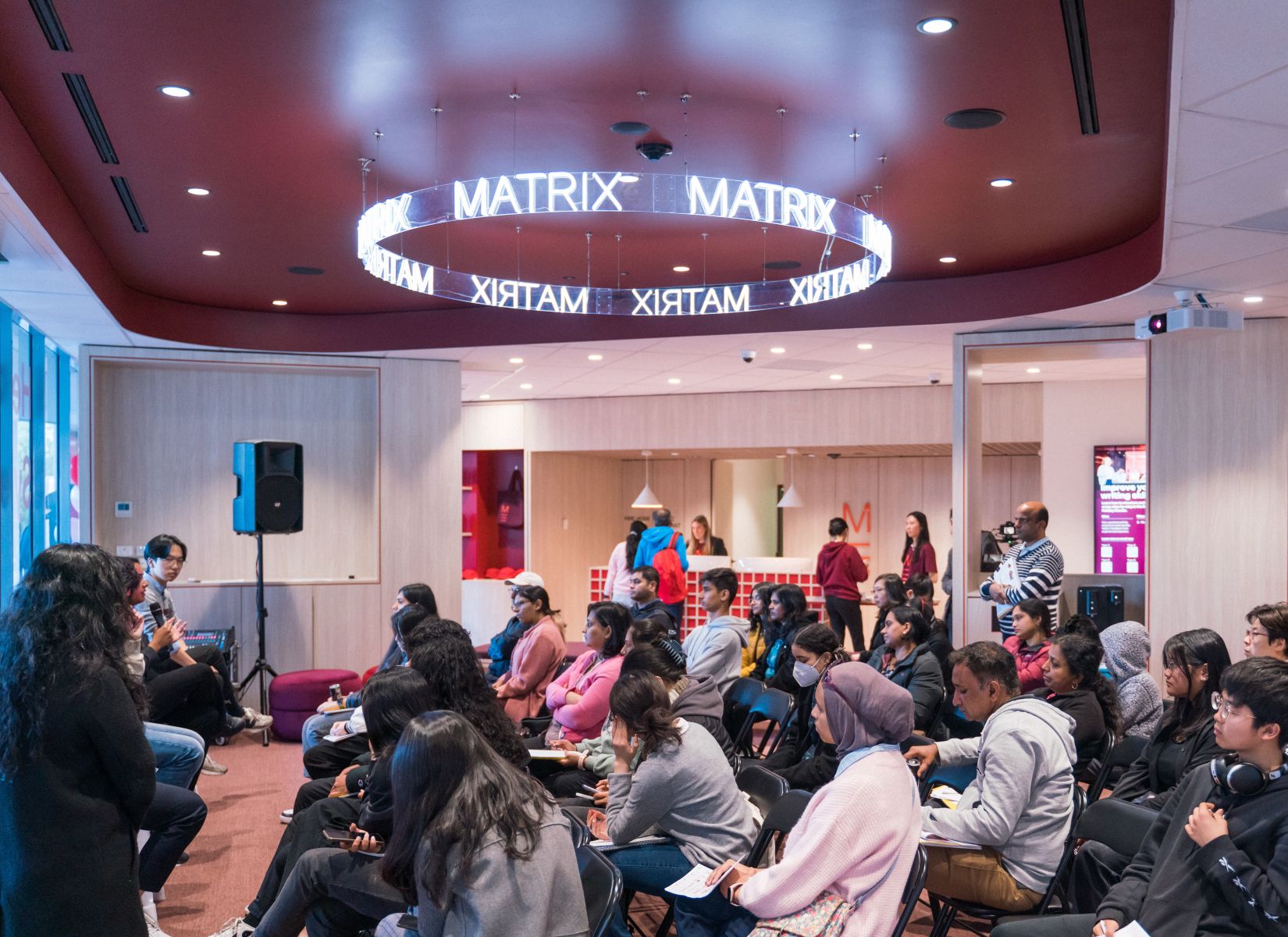 Custom Neon&reg; curved business name sign suspended from the ceiling @matrixeducation