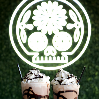 Mexican sugar skull Custom Neon® artwork in white LED neon flex mounted on a greenwall @delsurtacqueria