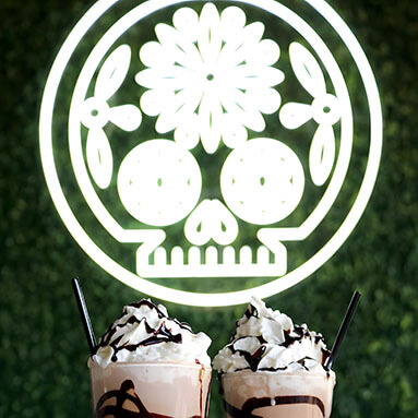 Custom Neon® white LED neon Mexican sugar skull artwork on grasswall
