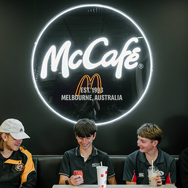Custom Neon® LED neon & UV print McDonalds Cafe sign on a black wall in a McDonalds fast food store