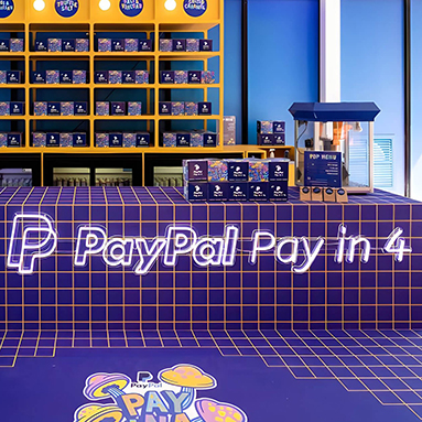 Custom Neon® white LED neon PayPal Pay in 4 sign on dark blue tiled wall