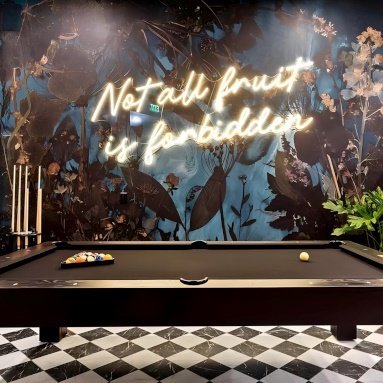 Large Custom Neon® quote sign on a dark wall in a games room designed by @khdesignconcepts