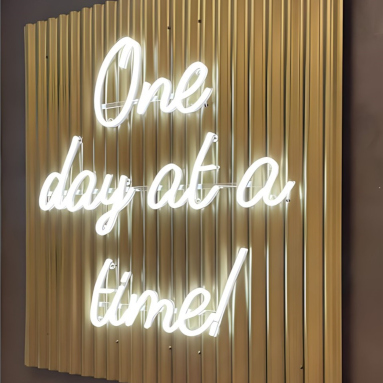 White One Day at a Time Custom Neon quote sign with Naked Neon™ backboard on gold corrugated iron wall @manon.prince.interiors