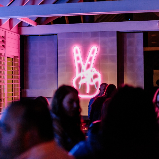 Pink peace Custom Neon® restaurant sign @wahwahgee