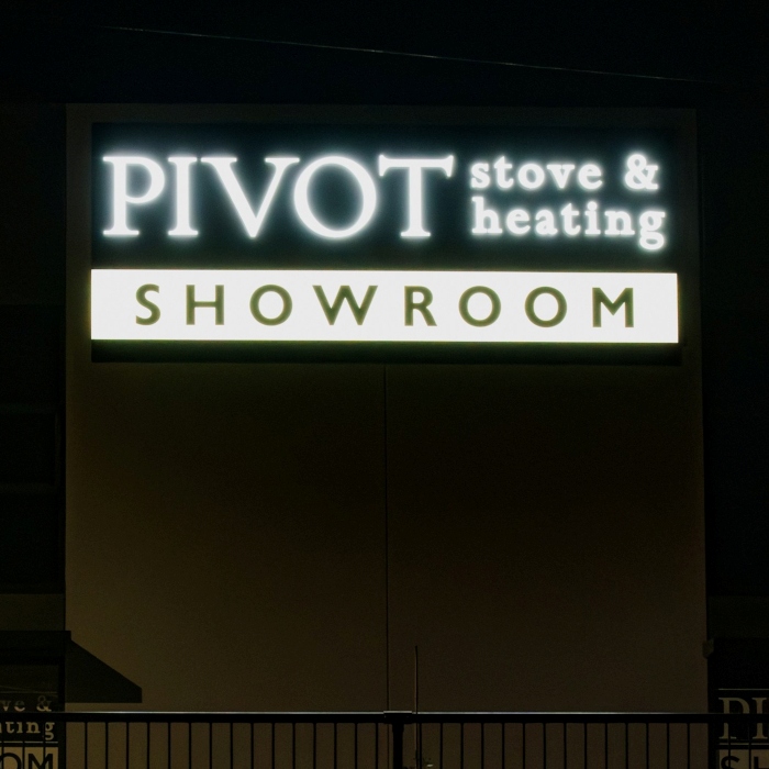 Close up of the Pivot Stove & Heating front lit white LED channel letter sign made by Custom Neon®