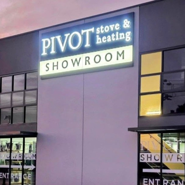 Close up of large front lit channel letters at the top of a double storey building at sunset