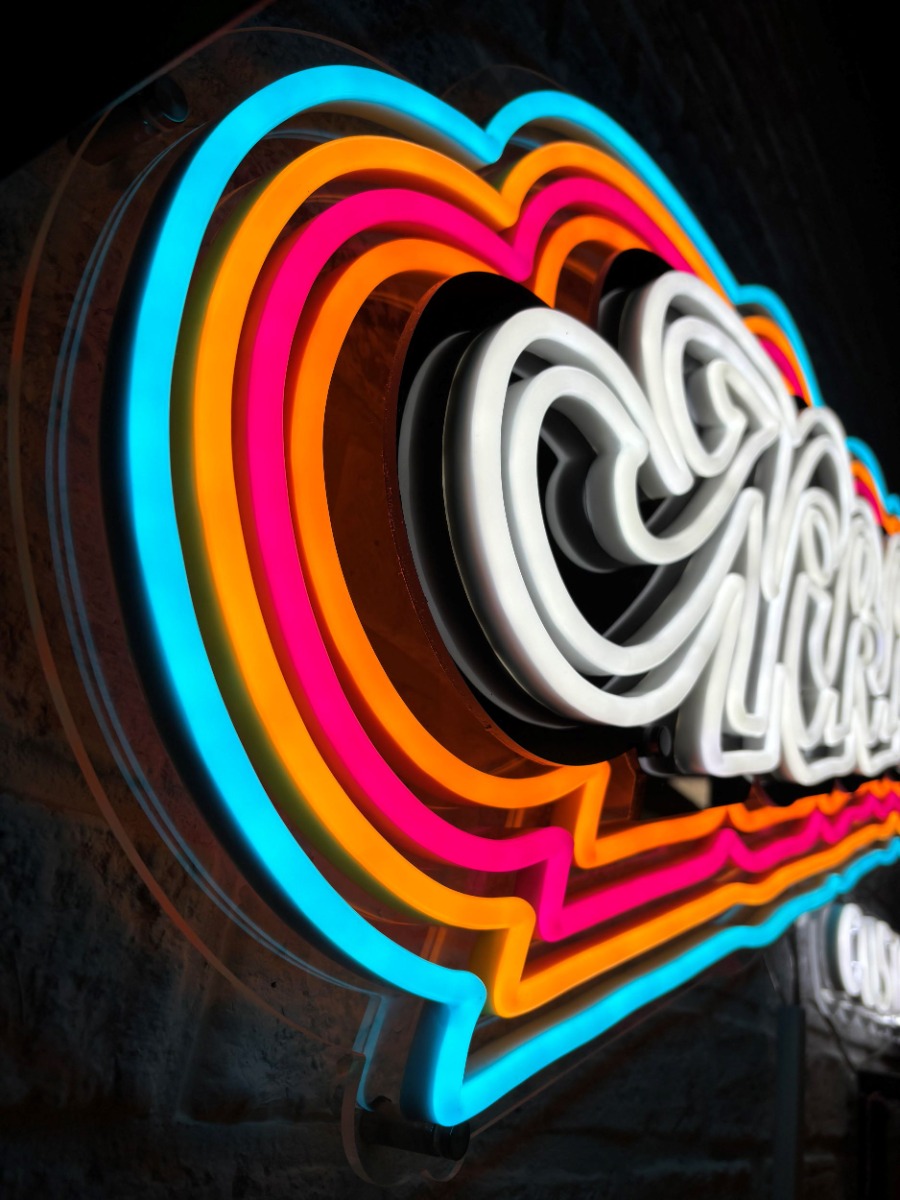 Custom Neon® retail sign in red, pink, orange and white on black backboard made for @nikkiscustard