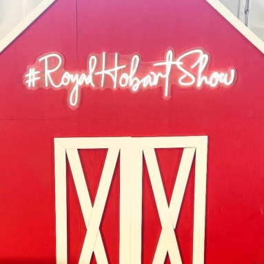 Custom Neon® sign for the Royal Hobart Show on a red and white barn @hobartshowgrounds