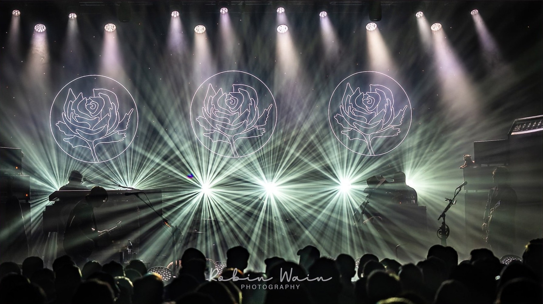 Custom Neon® large roses behind the performers at the Ryan Adams Cold Roses concert tour @christielites photos@robinwainphotography