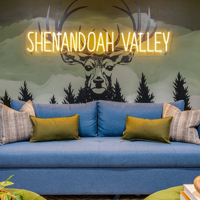 Shenandoah Valley warm white LED Custom Neon® sign on a mural of a stag in the woods above a sofa - interior decor by Somerled